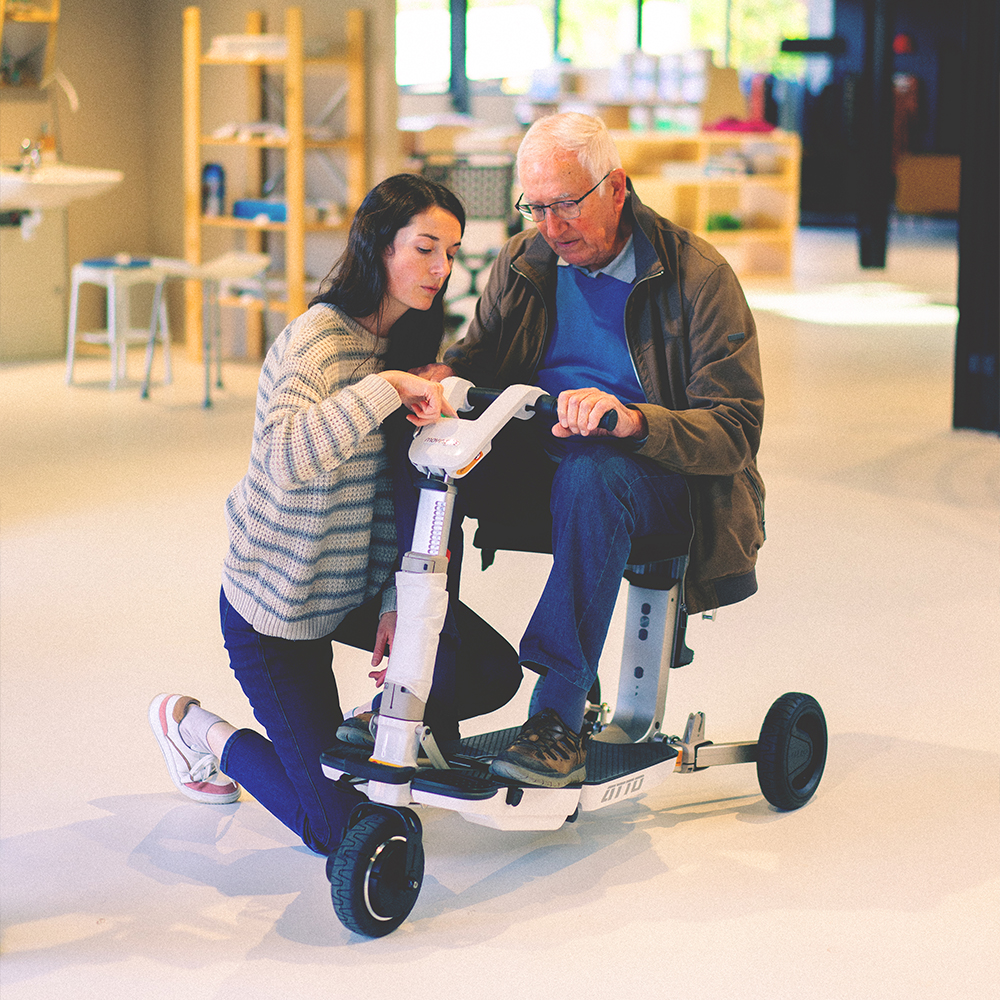A customer trying a mobility scooter in the showroom